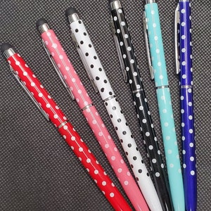 May include: Six polka dot pens with silver accents and black rubber tips. The pens are red, pink, white, black, light blue, and dark blue.
