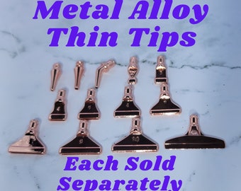 May include: Set of ten rose gold metal alloy thin tips for crafting. Each tip is numbered 1 through 10.  The tips are sold separately.  Each tip is shaped like a small spatula.