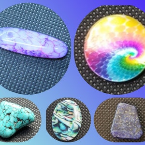 May include: Five different cabochons, a purple and white agate, a turquoise, a blue and green abalone shell, a rainbow tie-dye, and a blue lapis lazuli.
