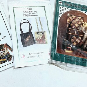 May include: Four sewing pattern booklets in clear plastic sleeves. The first is Quilter's Rucksack by Bethany Reynolds. The second is Lolly's Little Bag. The third is a green-bordered quilt pattern. The fourth is Yone's Origami Purse with pink accents.