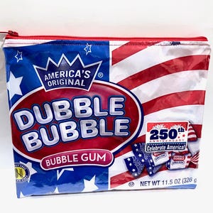 May include: A rectangular zippered pouch featuring a Dubble Bubble gum wrapper design with red, white, and blue colors, stars and stripes, and the text America's Original Dubble Bubble Bubble Gum 250th Anniversary Celebrate America! Net Wt 11.5 oz.