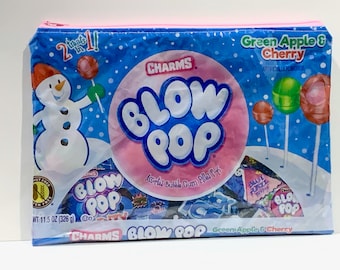May include: A blue and pink plastic bag with a zipper closure. The bag features a snowman, a large pink bubble gum ball with the text "CHARMS BLOW POP" and assorted bubble gum filled lollipops. The bag is labeled "Green Apple & Cherry" and "Assorted Bubble Gum Filled Pops".