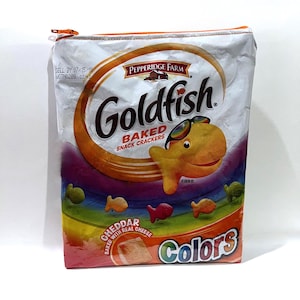 May include: A zippered pouch made from a Goldfish Colors snack cracker bag. The bag features a smiling goldfish wearing sunglasses, the words "Goldfish Baked Snack Crackers", and a rainbow design.