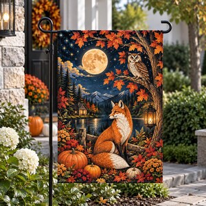 May include: A rectangular garden flag featuring a nocturnal autumn scene with a full moon, a perched owl, and a fox sitting among orange pumpkins and fall foliage. The landscape includes a lake, distant mountains, and a small cabin under a starry sky.