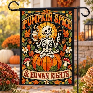 May include: A rectangular garden flag featuring a stained-glass style illustration of a skeleton sitting cross-legged on a large pumpkin. The skeleton holds a coffee cup and makes a peace sign. Text reads PUMPKIN SPICE & HUMAN RIGHTS.