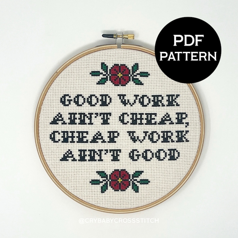 May include: A white embroidery hoop with a cross-stitch design that reads "Good work ain't cheap, cheap work ain't good". The design is in black text with red flowers and green leaves.