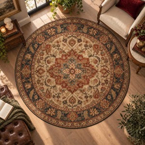 May include: A large round area rug featuring a central floral medallion in shades of rust red, cream, and deep blue. The rug has a wide dark blue border with intricate floral patterns and scrolling vines, creating a symmetrical design on a light background.