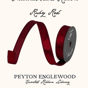 May include: A spool of ruby red velvet ribbon with a dark grey center core. The text reads Farrisilk Velvet Ribbon, Ruby Red, PEYTON ENGLEWOOD Curated Ribbon Library, and Haddonfield, NJ. The ribbon is unwound to show its deep red color and texture.
