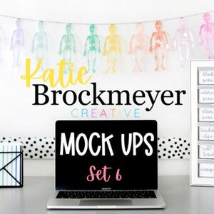 May include: A laptop computer on a desk with a black screen displaying the text "MOCK UPS Set 6". The laptop is on a white desk with a black and white polka dot patterned surface. There is a white shelf with black labels on the right side of the image.