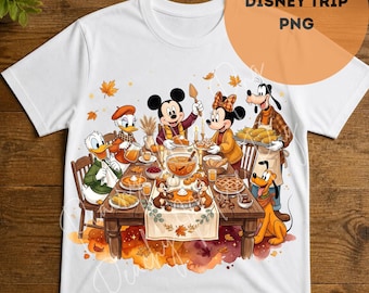 May include: A white t-shirt featuring a graphic illustration of Mickey Mouse, Minnie Mouse, Donald Duck, Daisy Duck, Goofy, Pluto, Chip, and Dale gathered around a wooden dining table set with autumn-themed food, pumpkins, and falling leaves.