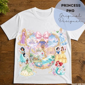 Puede incluir: Una camiseta blanca de manga corta con un gran marco central en forma de corazón adornado con un lazo rosa. Dentro del marco hay varios personajes de princesas animadas, castillos, un zapato de cristal, una rosa en una cúpula y escenas oceánicas.