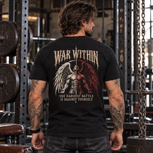 May include: A black short-sleeve t-shirt featuring a graphic on the back. The design shows a split figure with a white wing on one side and a red wing on the other. Text above reads WAR WITHIN and text below reads THE HARDEST BATTLE IS AGAINST YOURSELF.