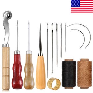 May include: A leather crafting tool set including a serrated tracing wheel with a wooden handle, two awls with wooden handles, a tapered awl, five straight needles, two curved needles, a metal thimble, and two spools of thread in black and tan.
