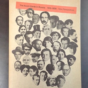 May include: A book cover with a beige background featuring a collage of black and white portraits. A red rectangular banner at the top reads "The Avant-Garde in Russia 1910-1930 New Perspectives".