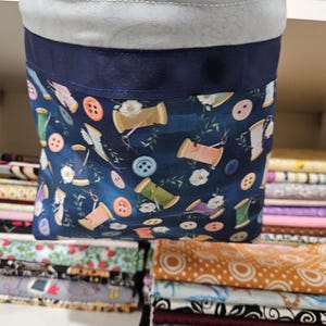 Scrap and thread catcher, snips bag with attached pin cushion, sits on the edge of your sewing table with gripping fabric