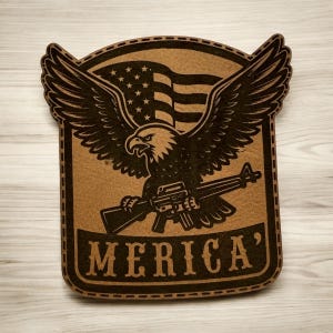 May include: A brown and black wooden plaque featuring an eagle with outstretched wings, holding a rifle, and the American flag in the background. The word "MERICA'" is displayed at the bottom of the plaque.
