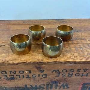 May include: A set of three ceramic mugs with a speckled, matte finish. The mugs are in shades of cream, light gray, and dark gray. Each mug has a simple, minimalist design and a rounded handle. The mugs are suitable for coffee, tea, or other beverages.