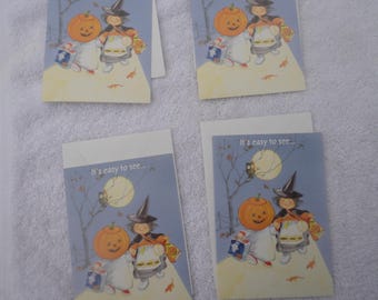 May include: Four Halloween greeting cards with a blue background and a full moon. The cards feature a witch and a child dressed as a pumpkin. The text on the cards reads "It's easy to see..."