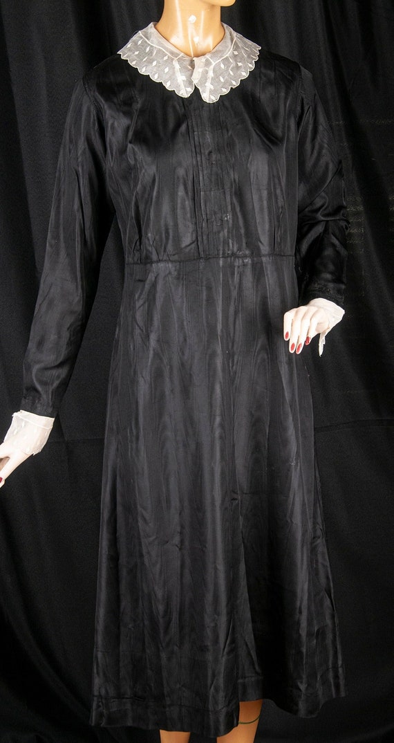1930s or 40s black moire satin uniform dress. Lace
