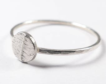 May include: A silver ring with a textured, circular leaf design.