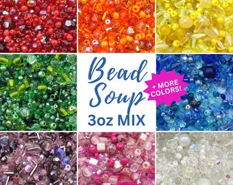 May include: A collection of assorted beads in red, orange, yellow, green, blue, purple, pink, and white, organized by color in a grid. The center square features the text Bead Soup 3oz MIX and a pink starburst with + MORE COLORS!.