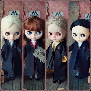 May include: Four dolls dressed in black robes with different colored accents. The dolls have long hair and are wearing black shoes. The dolls are standing in front of a wall with a sign that says "Ministry of Magic".