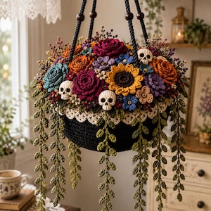 May include: A hanging crochet planter featuring a black bowl with a cream-coloured lace trim. The arrangement includes colourful crocheted flowers in shades of red, orange, yellow, blue, and purple, interspersed with small white skulls and green vines.