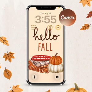 May include: A smartphone displaying a digital wallpaper with the text hello FALL in brown script and block letters. The screen features a watercolor illustration of a stack of folded plaid blankets next to an orange and a white pumpkin.
