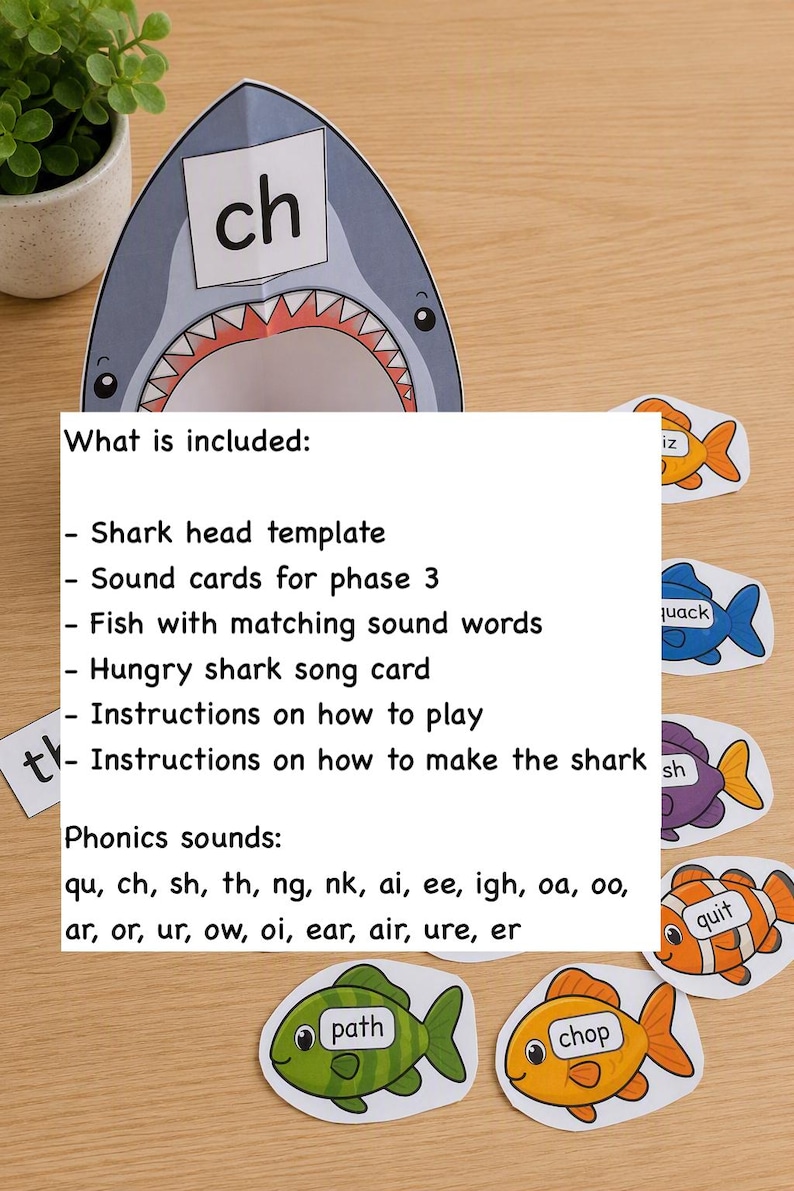 May include: A paper shark head template with the letters ch, accompanied by colorful fish cutouts labeled with phonics words like path, chop, and quit. The text lists included items such as a shark head template, sound cards, fish, a song card, and instructions for phonics sounds including qu, ch, sh, th, ng, nk, ai, ee, igh, oa, oo, ar, or, ur, ow, oi, ear, air, ure, and er.