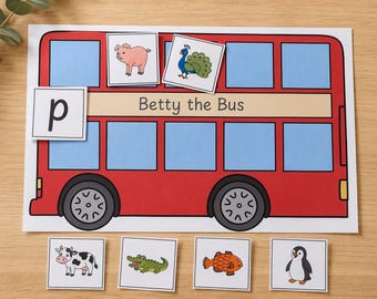 May include: A red bus illustration labeled Betty the Bus with blue windows and black wheels. The set includes a square card with the letter p and six square cards featuring illustrations of a pig, peacock, cow, crocodile, fish, and penguin.