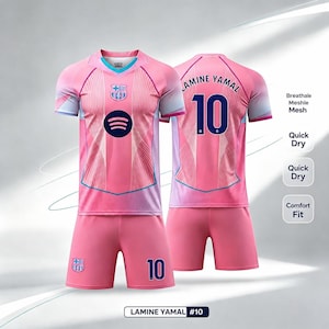 May include: A pink soccer jersey and shorts set featuring the FC Barcelona crest, a Spotify logo, and the name Lamine Yamal with the number 10 in dark blue. The jersey includes text labels for breathable mesh, quick dry, and comfort fit features.