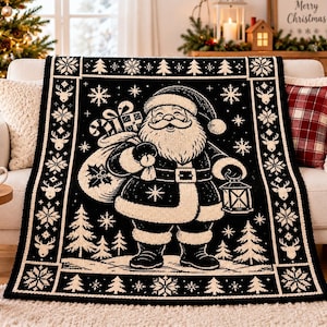 May include: A black and cream-colored throw blanket featuring a central illustration of Santa Claus carrying a sack of gifts and a lantern. The border is decorated with repeating patterns of reindeer, snowflakes, and pine trees.