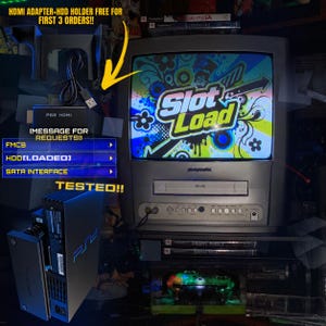 May include: A black PlayStation 2 console with a SATA interface and loaded hard drive, connected to a CRT television displaying the Slot Load game title. Includes an HDMI adapter, HDD holder, and a green translucent controller.