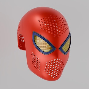 May include: A bright red full-face mask featuring a perforated texture across the forehead and mouth area. The mask includes two large, angular eye openings framed in dark blue, with a yellow mesh screen covering the interior of each eye section.