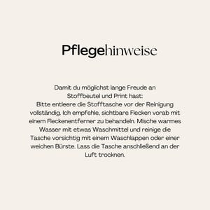 May include: A white informational card with black text titled Pflegehinweise. The text provides instructions for cleaning a fabric bag, including emptying the bag, spot treating stains, washing with warm water and detergent, and air drying.