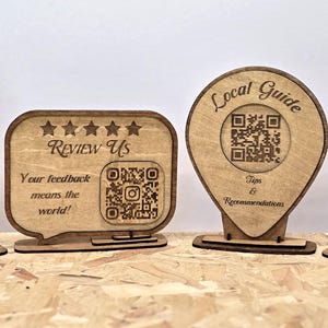 May include: Four light brown wooden signs with laser-engraved text and graphics. The first is car-shaped with 'Parking Info', the second is a speech bubble with 'Review Us' and a QR code, the third is a map pin with 'Local Guide' and a QR code, and the fourth is a bin shape with a recycling symbol and placeholder text.