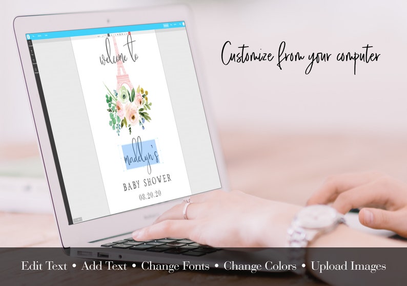 May include: A laptop displays a baby shower invitation design. The invitation features a watercolor Eiffel Tower, floral accents, and the text "Welcome to Madelyn's Baby Shower 08.20.20." The screen also shows editing options: Edit Text, Add Text, Change Fonts, Change Colors, and Upload Images.