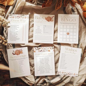 Peut inclure: Un ensemble de jeux de baby shower imprimables sur le thème de l'automne. Les jeux comprennent "Devinez qui", "Prédictions de bébé", "Bingo de baby shower", "Le prix est juste", "Maman préférerait-elle", et "Vœux pour bébé". Les jeux présentent une palette de couleurs automnales avec des accents orange, brun et jaune.