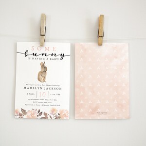 May include: A pink and white baby shower invitation with a watercolor bunny illustration and the text "Some bunny is having a baby!"  The invitation includes the name "Madelyn Jackson" and the date "April 10".