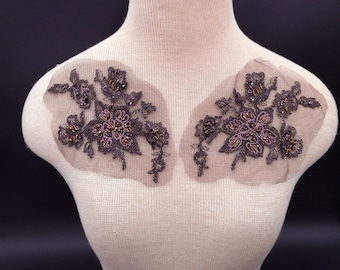 May include: Two brown floral appliques with beaded accents on a white background.