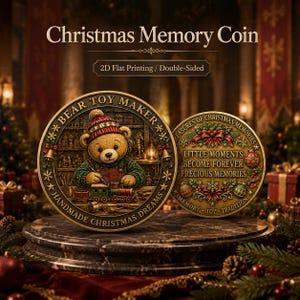May include: A double-sided Christmas memory coin featuring a bear toy maker in a workshop on one side and the text 'LITTLE MOMENTS BECOME FOREVER PRECIOUS MEMORIES' surrounded by festive holly, ribbons, and ornaments on the reverse side.