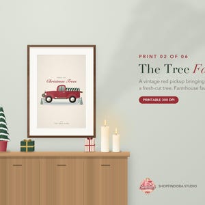 May include: A framed wall art print featuring a red vintage pickup truck carrying a green Christmas tree, with the text "Christmas Trees" and "The Tree Farm" displayed on a cream background, presented in a dark brown wooden frame.