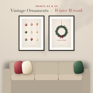 May include: Two framed wall art prints titled Prints 03 & 04. The left print displays nine vintage ornaments in various shapes and colors. The right print features a green winter wreath with a red bow and the text Deck the Halls below it.