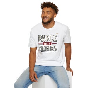 May include: A white short-sleeved t-shirt featuring the text PARCE QUE CHIMBA in a bold, collegiate-style font. The word QUE is centered within a maroon rectangular banner, and the entire graphic design is printed in black, white, and maroon.