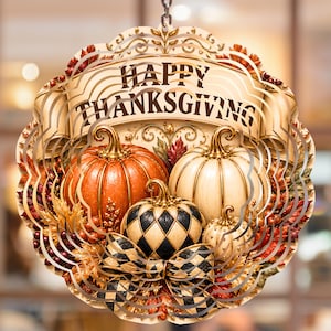 May include: A circular hanging wind spinner featuring a banner with the text HAPPY THANKSGIVING. The design includes a large orange pumpkin, a white pumpkin, and a smaller black and white checkered pumpkin with a matching bow.