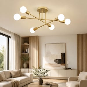 May include: A six-light ceiling fixture featuring a central brass-toned metal hub with thin, radiating arms. Each arm terminates in a cylindrical socket holding a round, white frosted glass globe bulb, creating a symmetrical, multi-directional light.