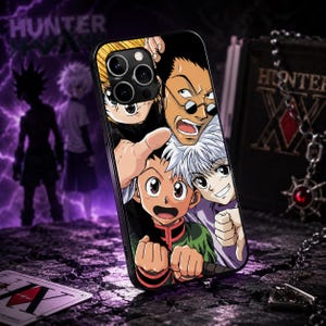May include: A black smartphone case featuring a colorful anime graphic of four characters from Hunter x Hunter, including Gon and Killua, with a prominent camera cutout at the top left corner and a sleek, durable finish for mobile protection.