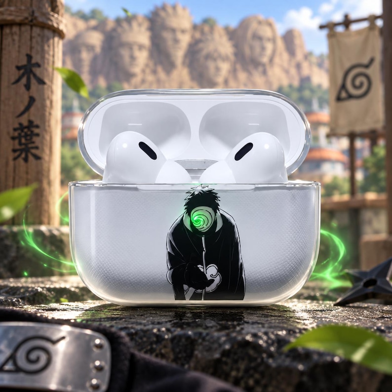 May include: A clear protective case for wireless earbuds featuring a graphic of a masked character in a black cloak with a swirling green eye design. The case is open, revealing white earbuds inside, and the exterior has a subtle textured finish.