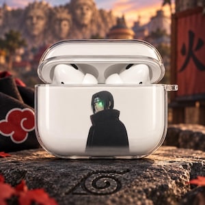 May include: A clear protective case for wireless earbuds featuring a printed graphic of a dark-haired character wearing a black high-collared cloak. The case is transparent, showing the white earbuds inside, and has a hinged lid and a side loop.