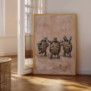 May include: A framed rectangular wall art piece featuring a painting of three tortoises standing upright on a textured, light brown background. The tortoises are depicted in a row, with the central one facing forward and the two side ones angled.